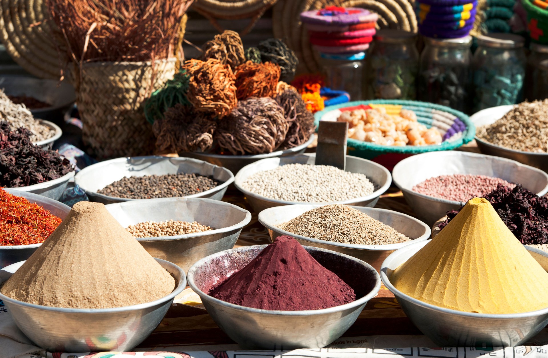 Spice bowls at market typify the colours, designs and traditions of a Nubian Village, Aswan, River Nile, Egypt